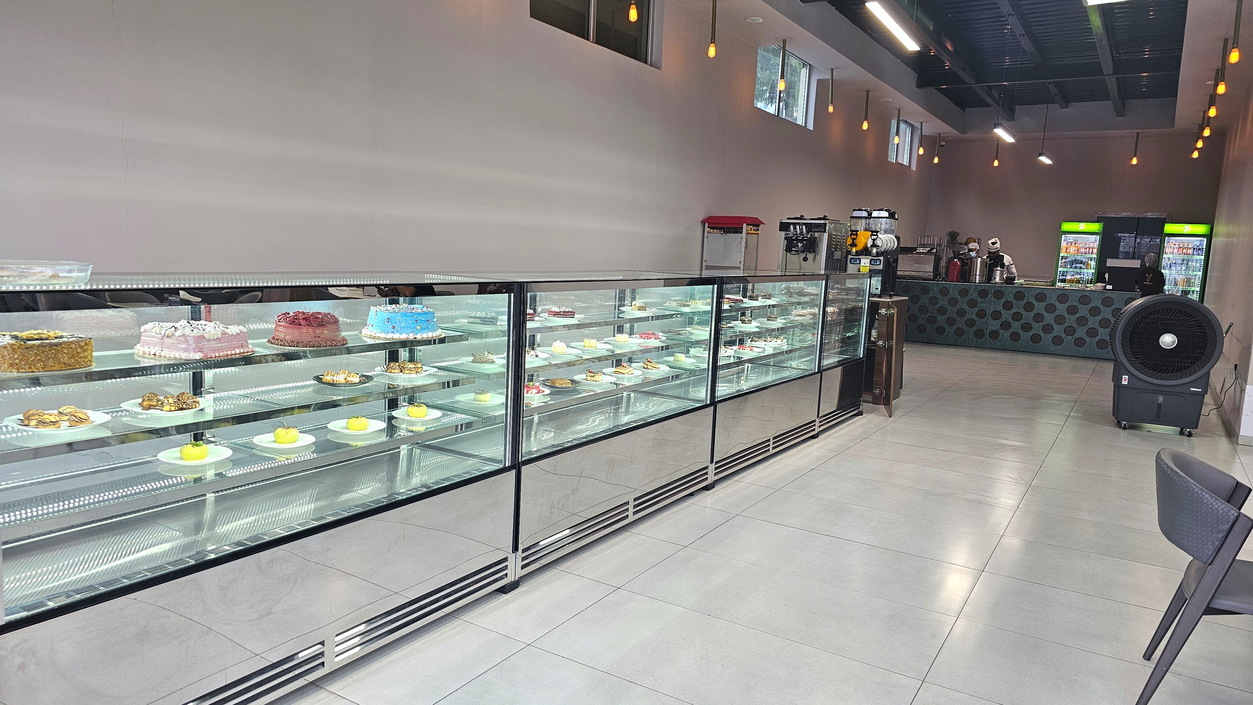Pastry and cake display in the cafe at Musk
